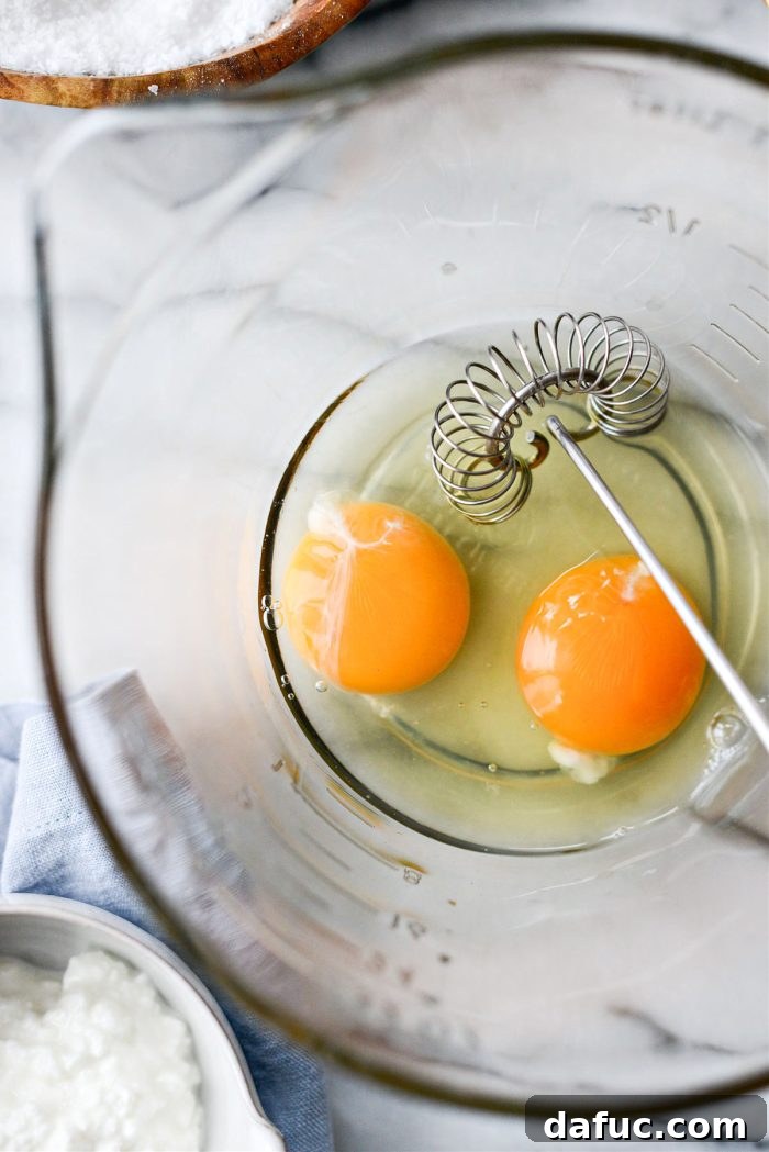 Creamy Cottage Scrambled Eggs 6 Cracking two large eggs into a measuring cup