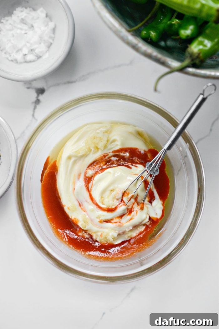 Whisking aioli ingredients together for a smooth consistency