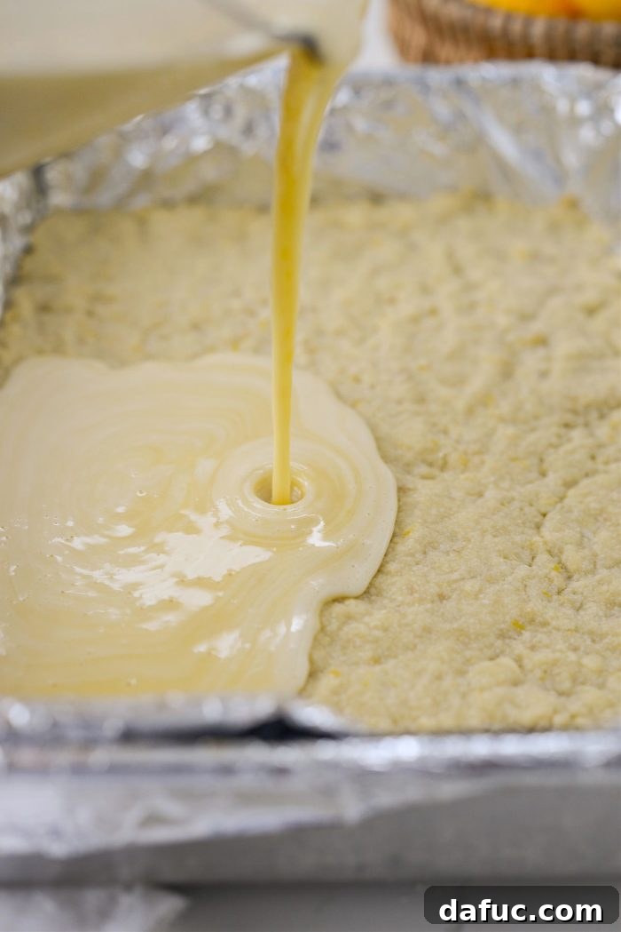 Pouring the Meyer lemon filling onto the hot, partially baked shortbread crust