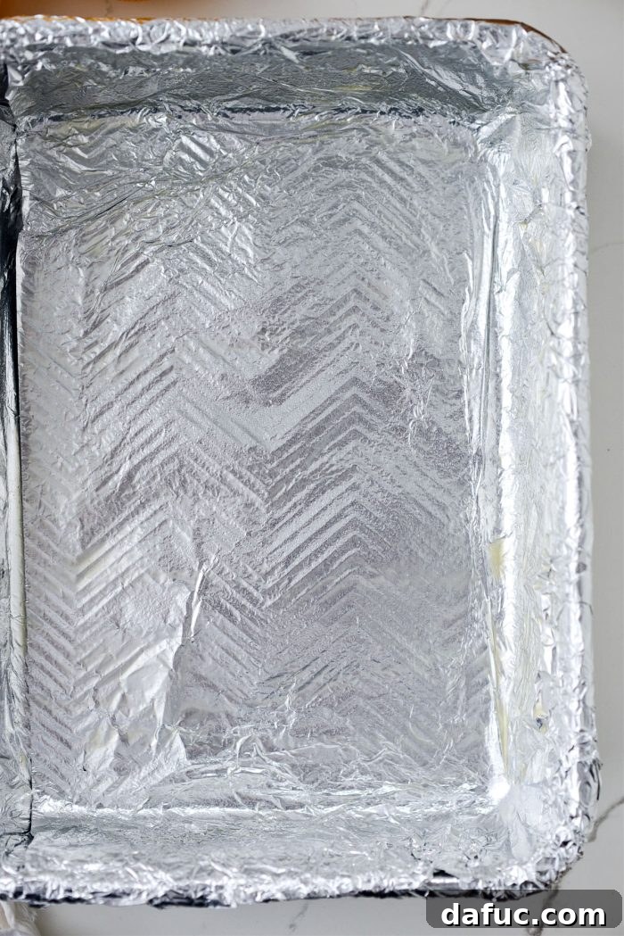 9x13 cake pan lined with foil and greased for Meyer Lemon Bars