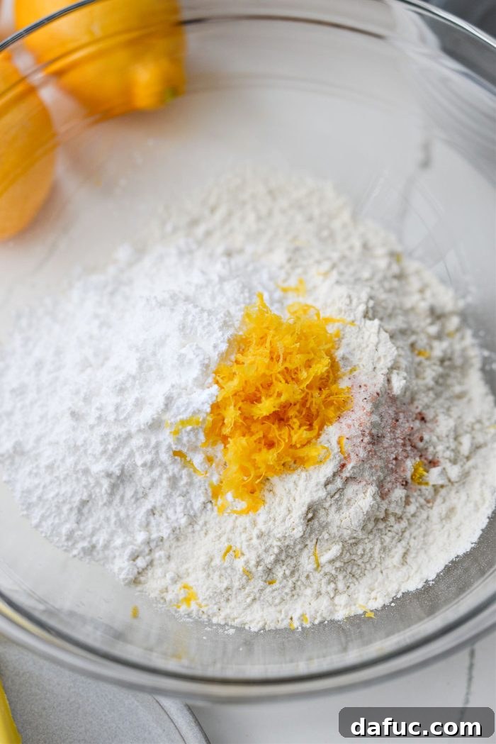 Dry ingredients for shortbread crust in a mixing bowl: flour, powdered sugar, lemon zest, and salt