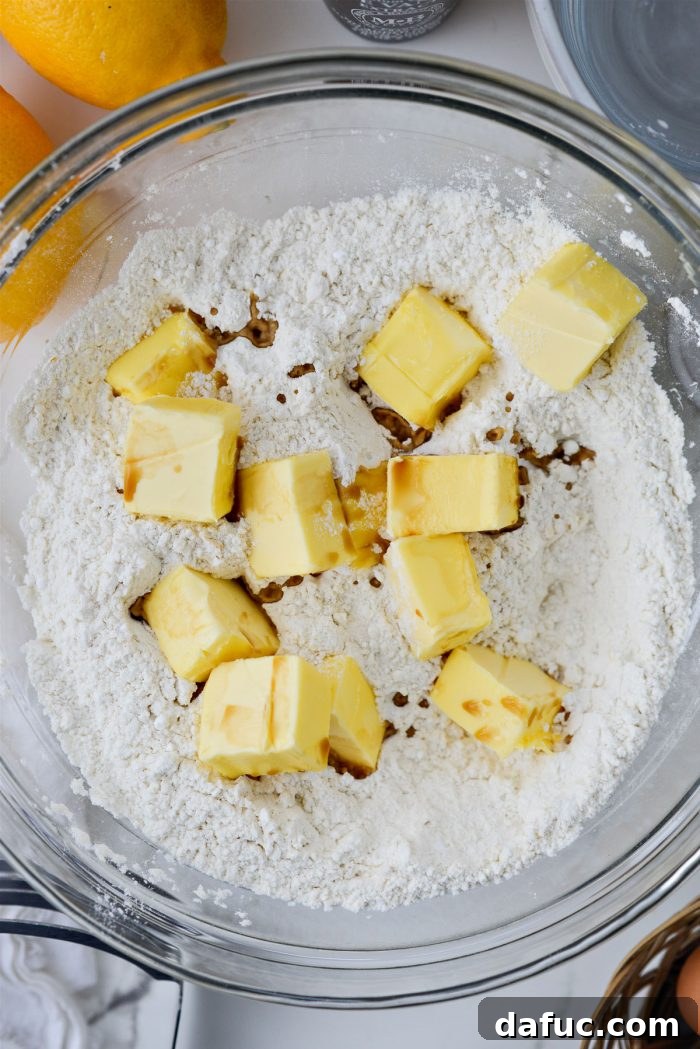 Adding room temperature butter and vanilla extract to the dry crust ingredients