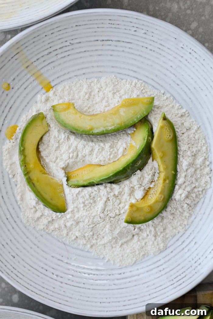 Coating avocado wedges in flour