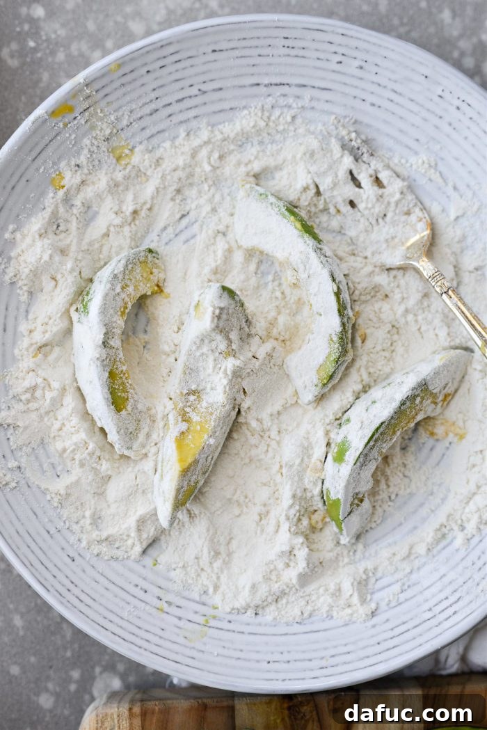 Avocado wedges fully coated in flour