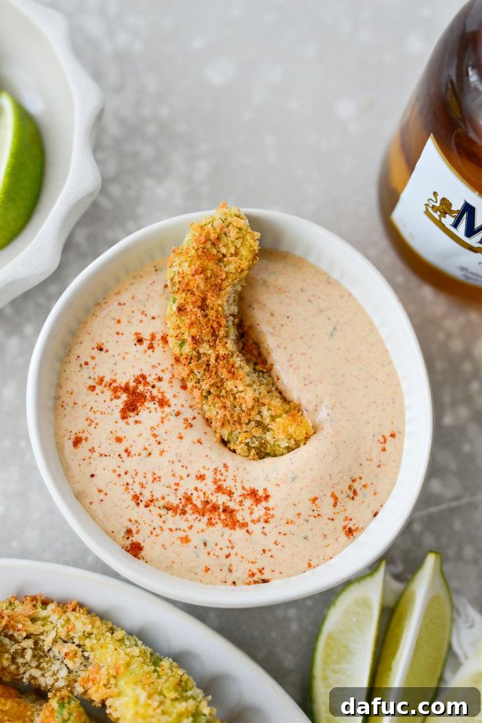 A vibrant platter of Air Fryer Avocado Fries with dipping sauce