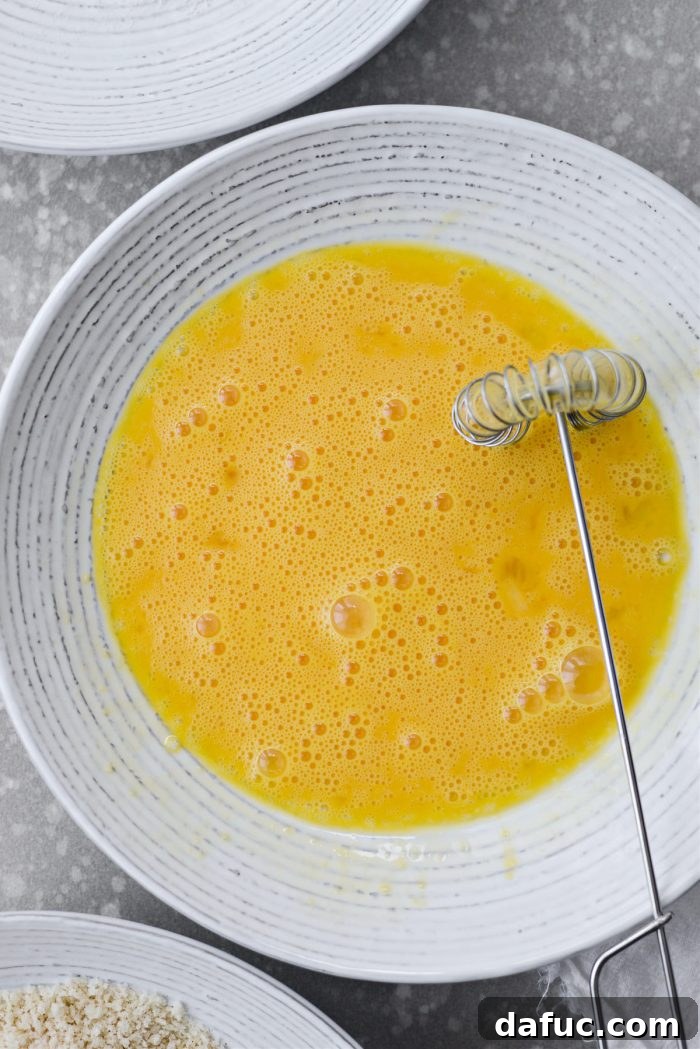 Beaten eggs in a bowl for avocado fry coating