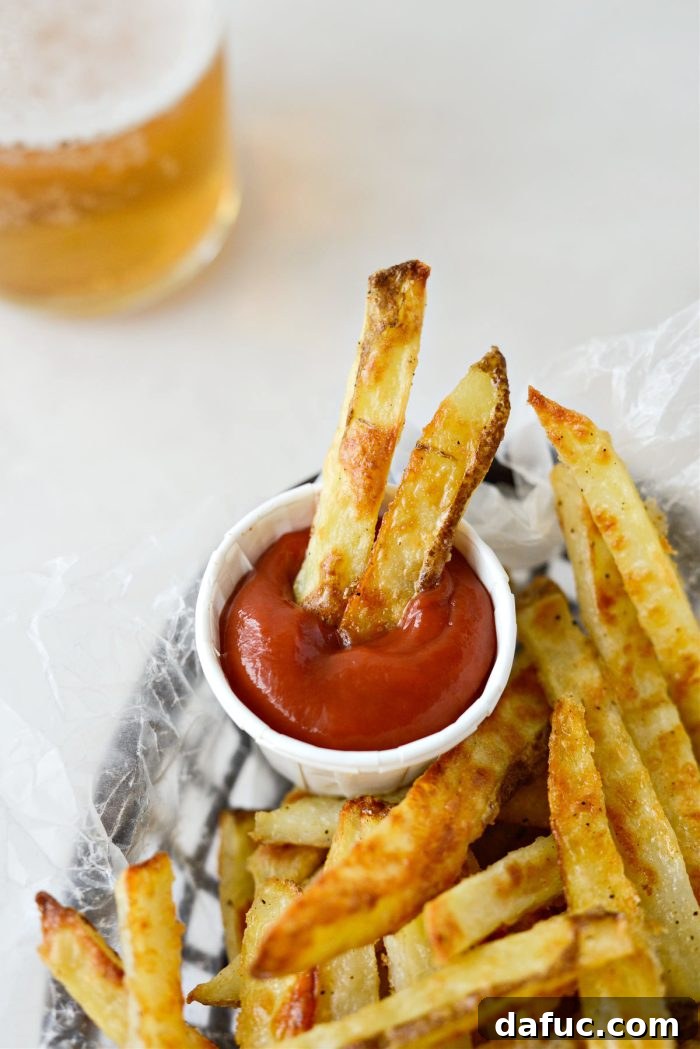 Golden Crispy Oven Fries 21 A close-up shot of perfectly cooked oven baked French fries, highlighting their texture.