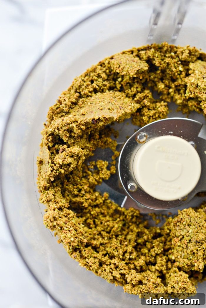 Pistachios in the food processor, now forming a thick, green paste as oils release.
