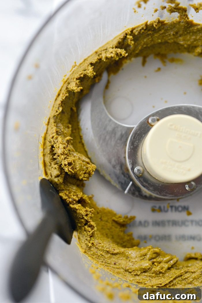 Pistachio butter looking thick and slightly smooth, but still needing more processing.