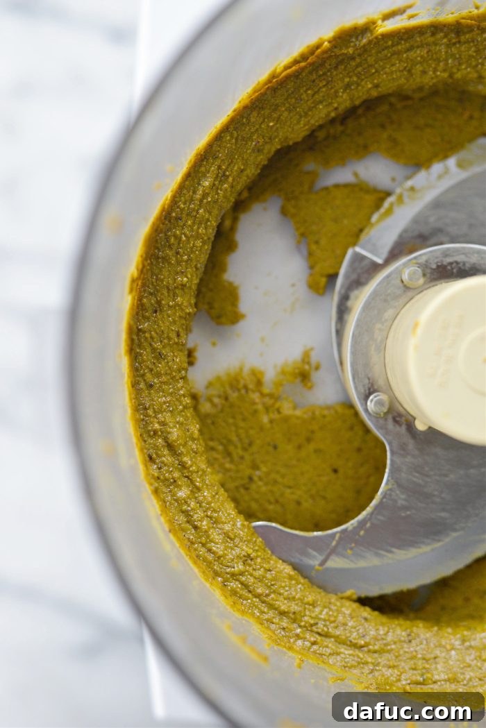 Fully processed, creamy homemade pistachio butter in the food processor bowl.