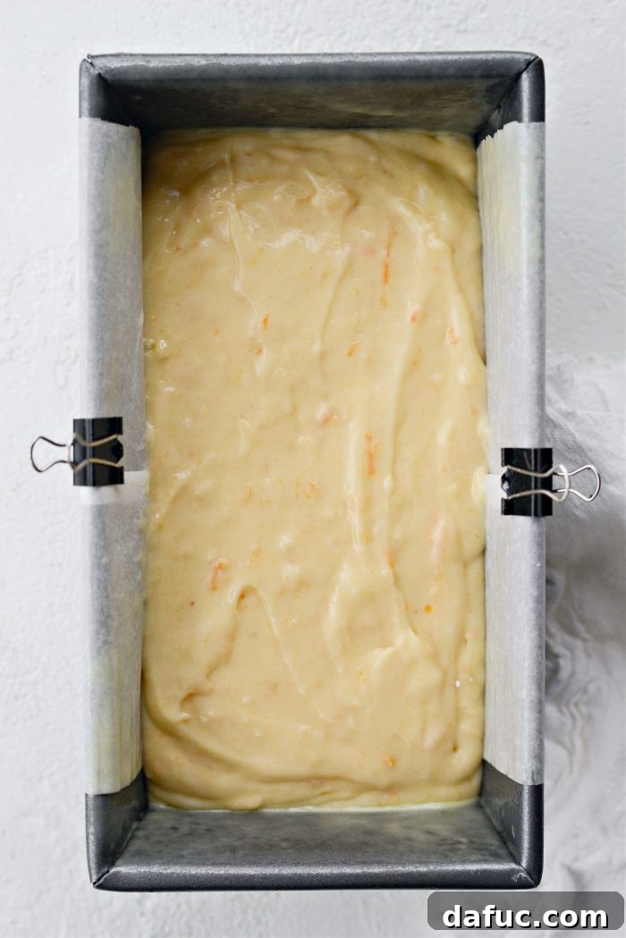 Creamy Grapefruit Zing Cake 13 Cake batter poured into the lined loaf pan and smoothed on top