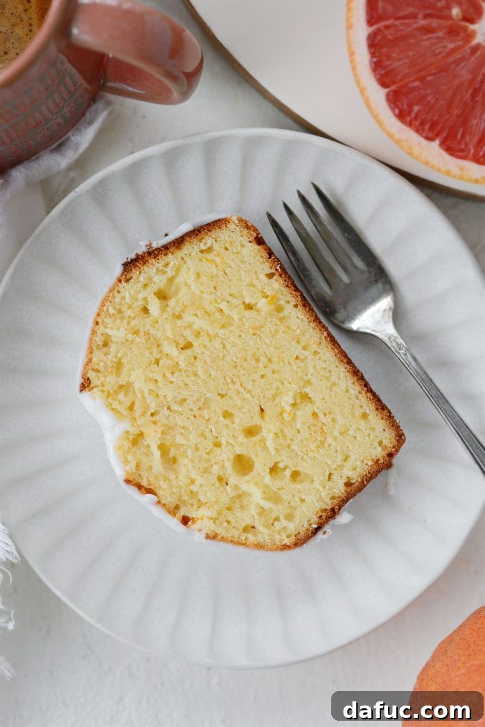 Creamy Grapefruit Zing Cake 19 A full Grapefruit Sour Cream Cake on a serving plate, inviting a second slice