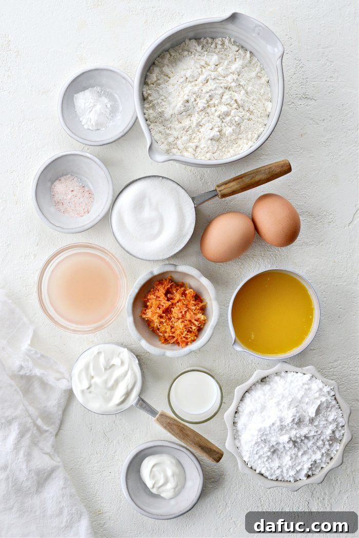 Creamy Grapefruit Zing Cake 4 Ingredients for Grapefruit Sour Cream Cake laid out on a counter, including flour, sugar, grapefruits, eggs, butter, and sour cream