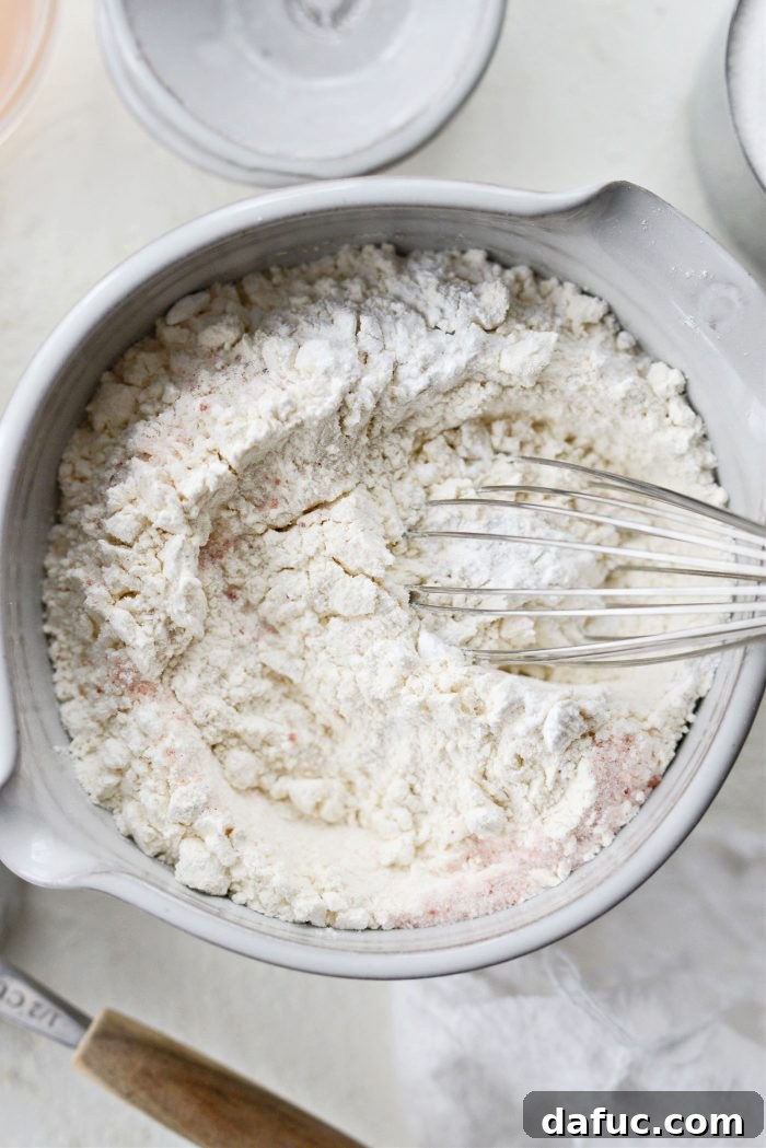 Creamy Grapefruit Zing Cake 6 Dry ingredients - flour, salt, and baking powder - being whisked together in a medium bowl