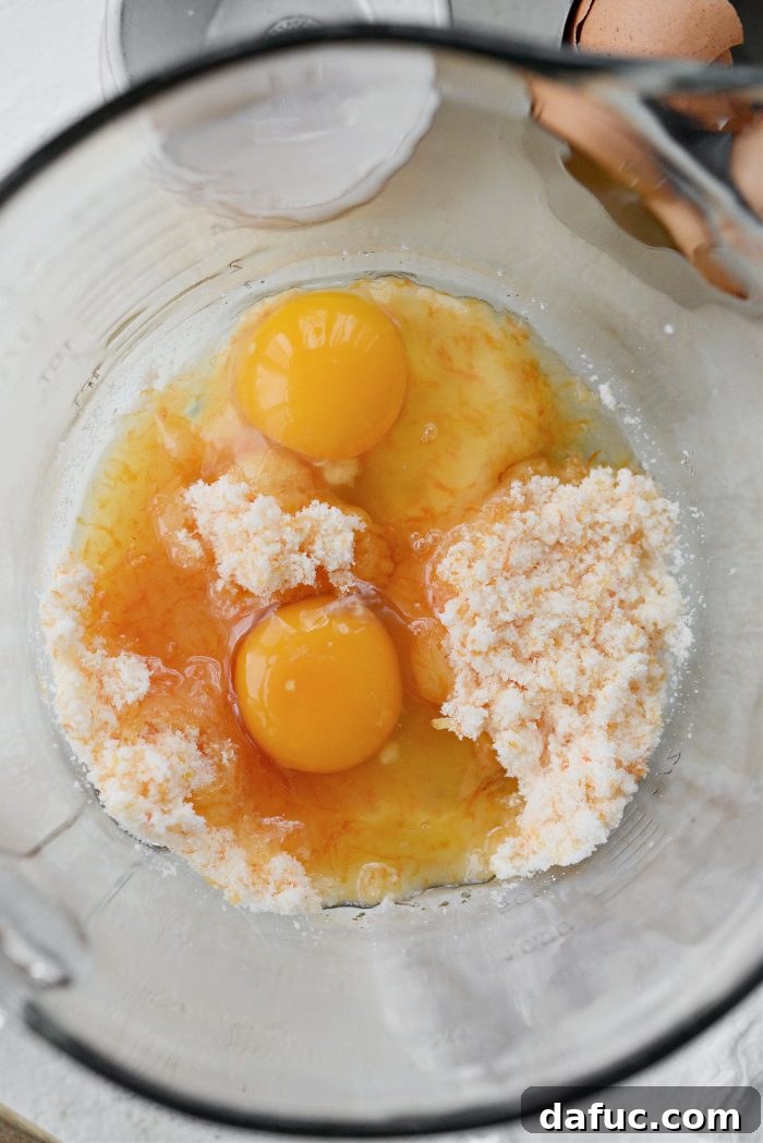 Creamy Grapefruit Zing Cake 8 Melted butter, eggs, and grapefruit juice being added to the grapefruit zest and sugar mixture