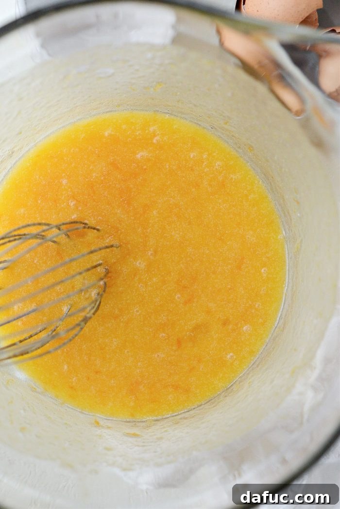 Creamy Grapefruit Zing Cake 9 The wet ingredients (sugar, zest, eggs, grapefruit juice, butter) being whisked together until smooth