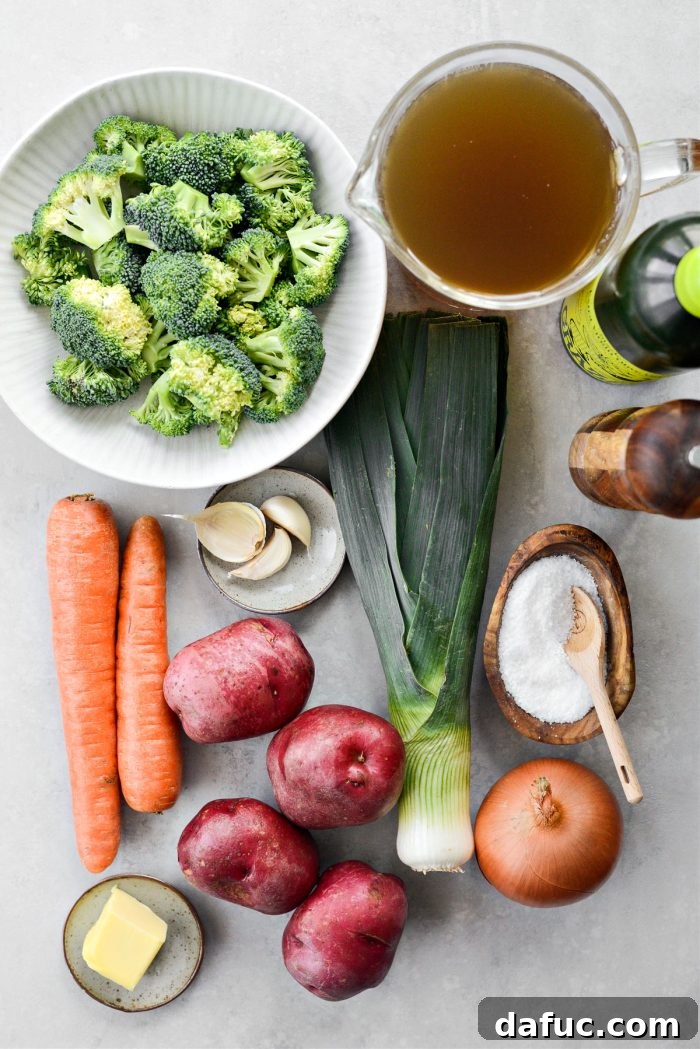 Hearty Irish Vegetable Soup 4 Fresh ingredients laid out for making Irish Vegetable Soup, including potatoes, carrots, onions, leeks, garlic, and broccoli.