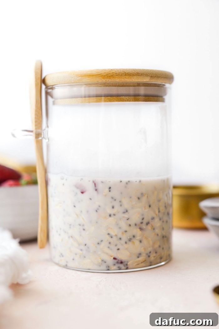 Creamy Strawberry Overnight Oats 9 A glass jar of overnight oats, covered and ready for refrigeration.