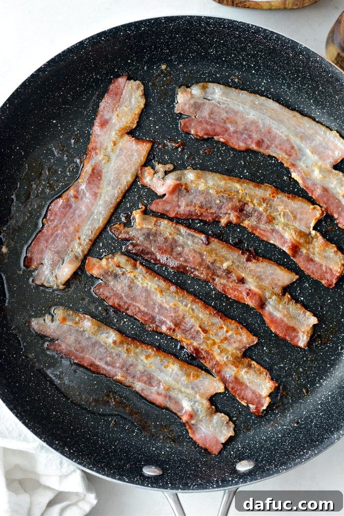 Bacon cooking in a pan until crispy