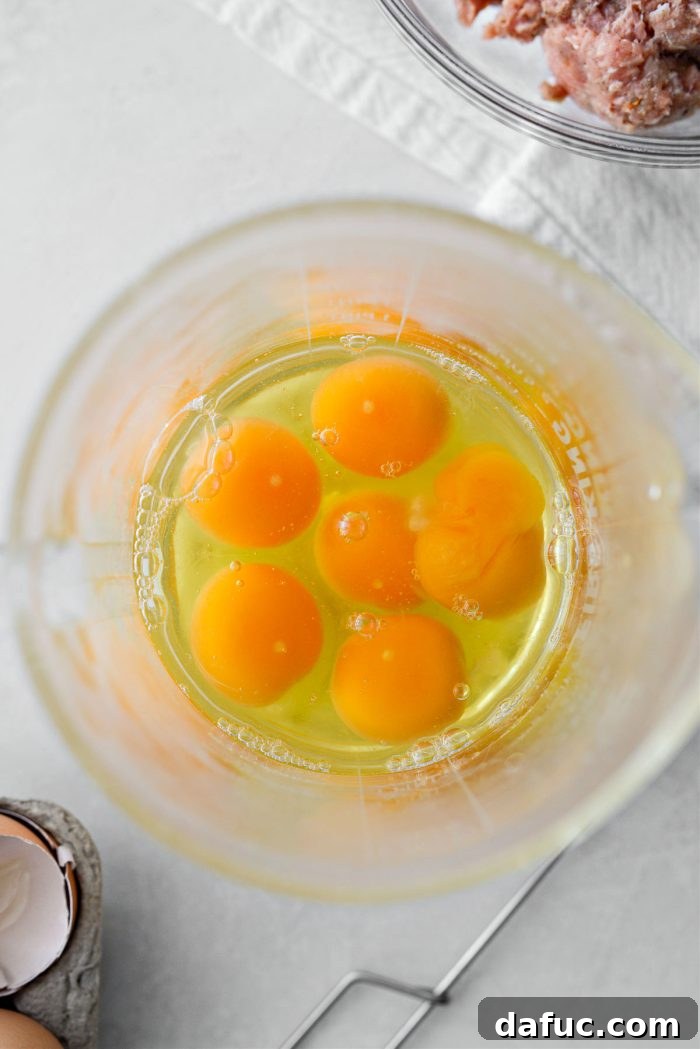 Six large eggs cracked into a bowl