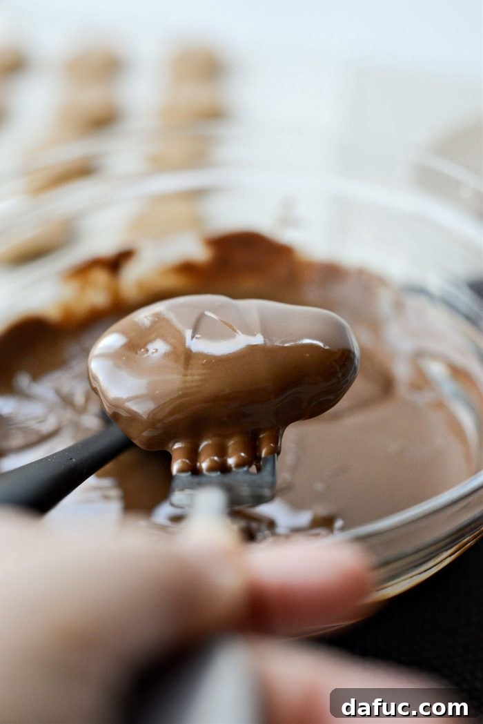 Lift and gently tap off excess chocolate