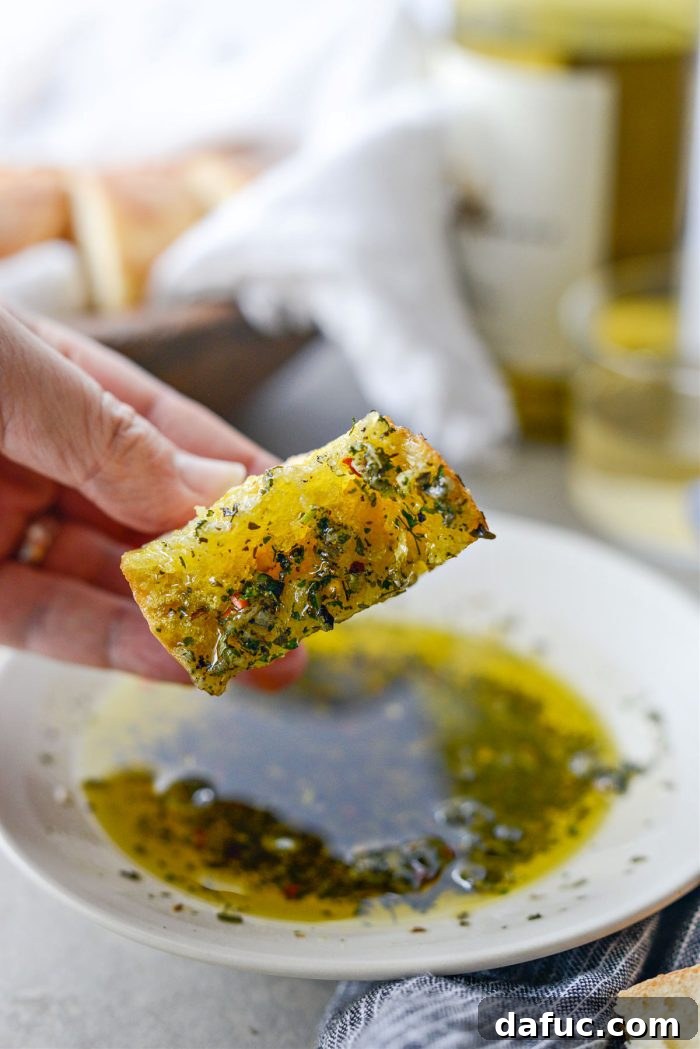 Garlic Herb Infused Dipping Oil 14 Close-up of Garlic Herb Olive Oil Bread Dip with fresh herbs