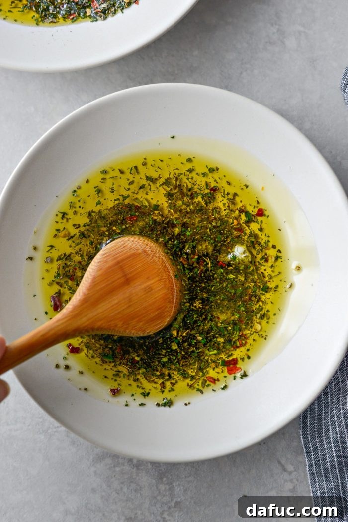 Garlic Herb Infused Dipping Oil 10 Gently stirring the garlic, herbs, and olive oil to combine