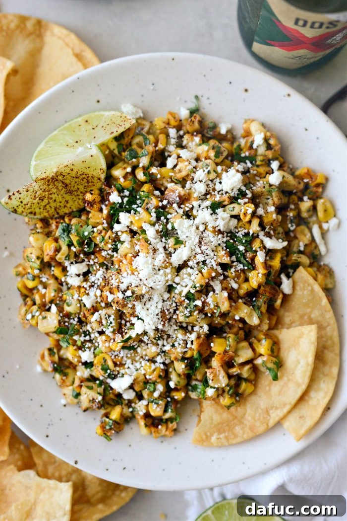 Zesty Mexican Street Corn Dip 2 Vibrant Mexican Street Corn Salsa served in a bowl, garnished with cilantro and cotija cheese