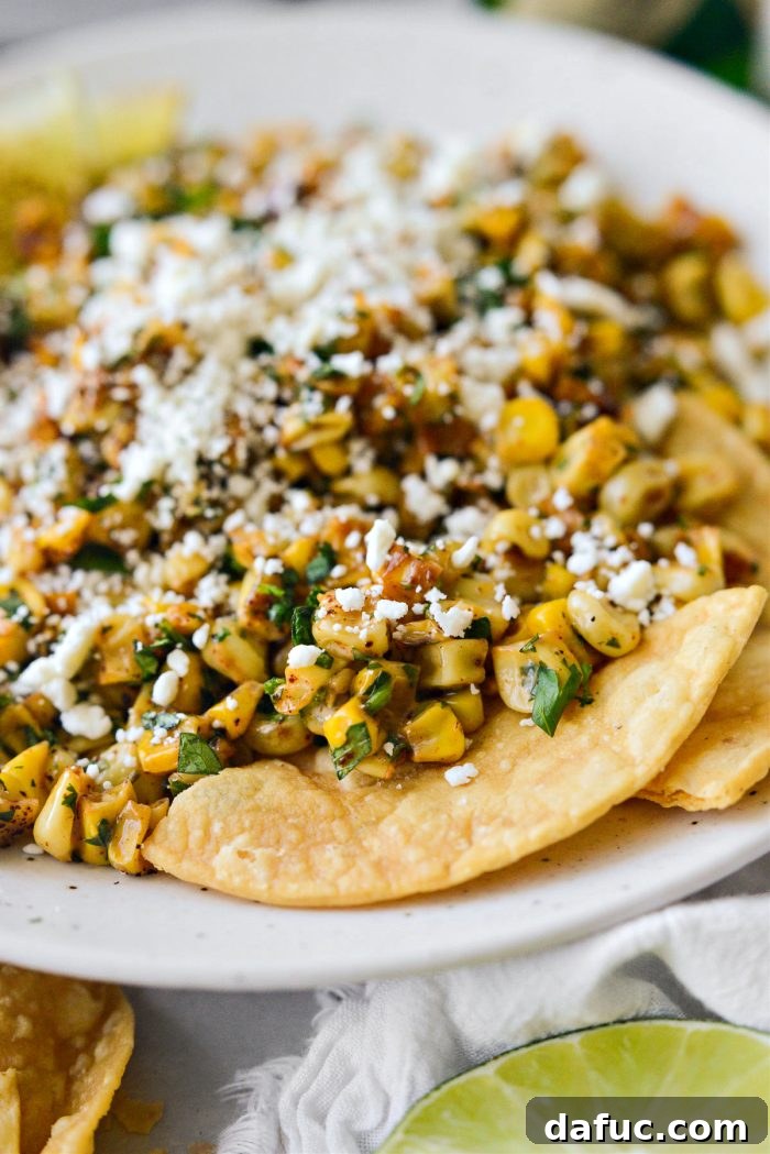 Zesty Mexican Street Corn Dip 11 A scoop of Mexican Street Corn Salsa in a serving spoon