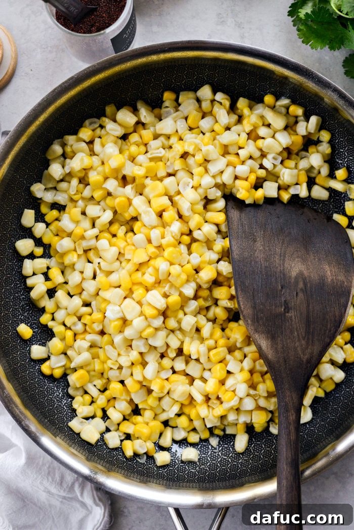 Zesty Mexican Street Corn Dip 5 Thawed corn spread in a skillet, ready for charring