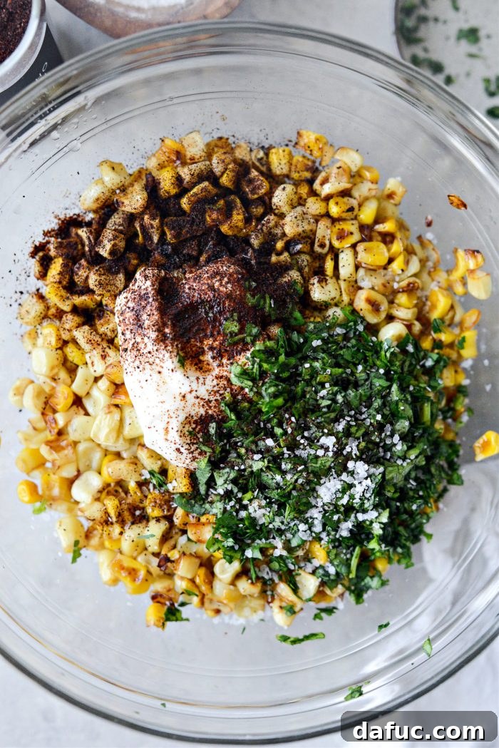 Zesty Mexican Street Corn Dip 7 Charred corn and other salsa ingredients in a mixing bowl