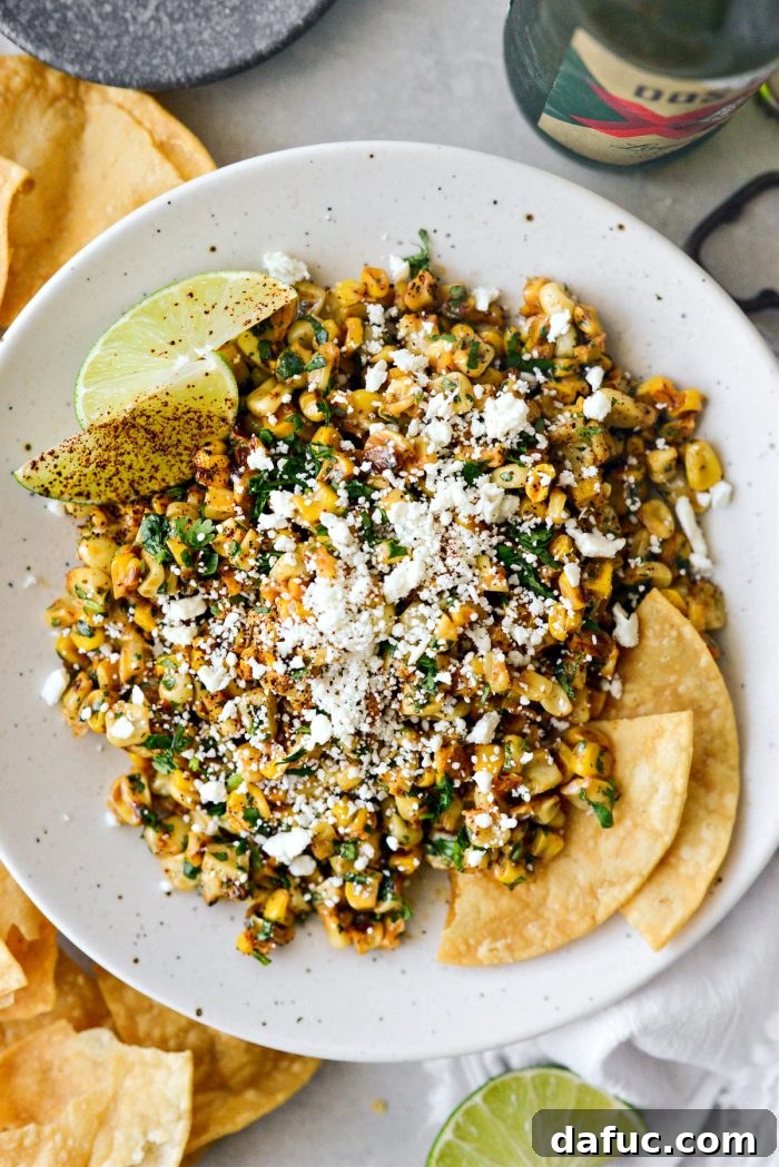 Zesty Mexican Street Corn Dip 9 Finished Mexican Street Corn Salsa in a serving bowl, garnished with cheese and cilantro