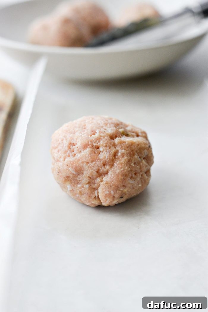 Shaping chicken into balls