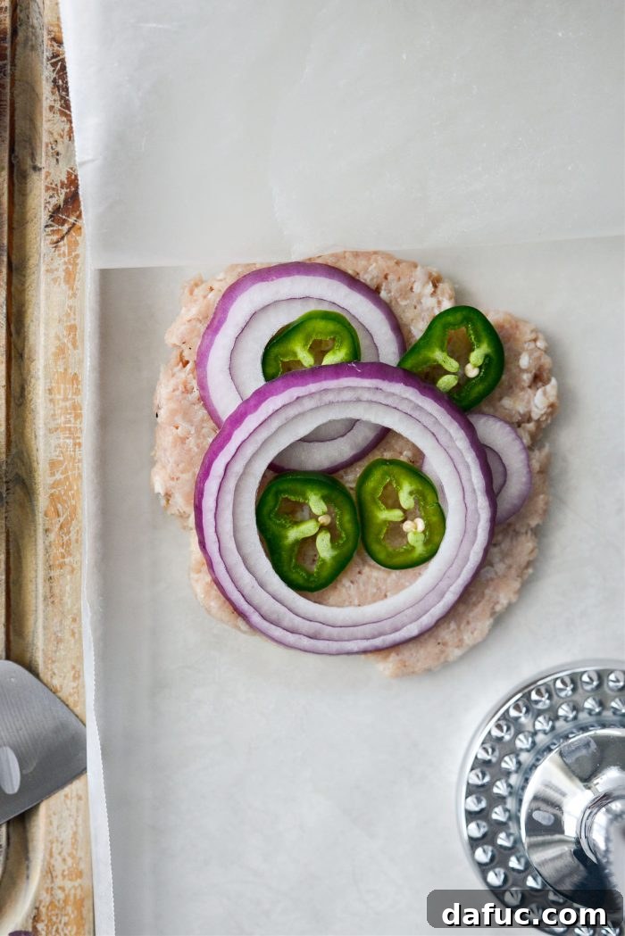 Pressing chicken patty with wax paper