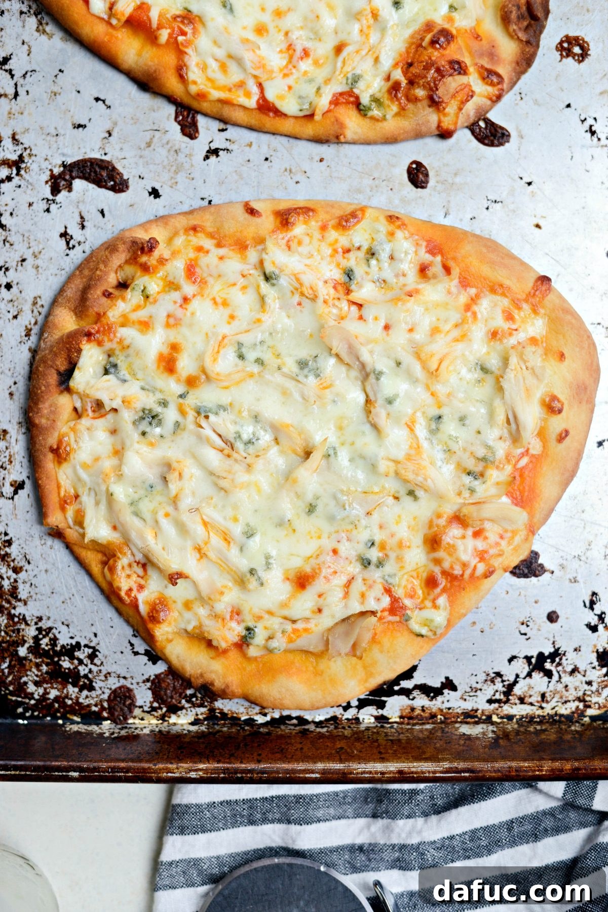 Freshly baked Buffalo Chicken Flatbread Pizzas, hot from the oven with melted cheese.