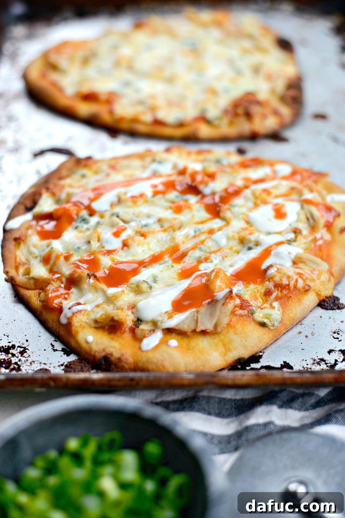 Buffalo Chicken Flatbread Pizzas drizzled with extra buffalo sauce and blue cheese dressing.