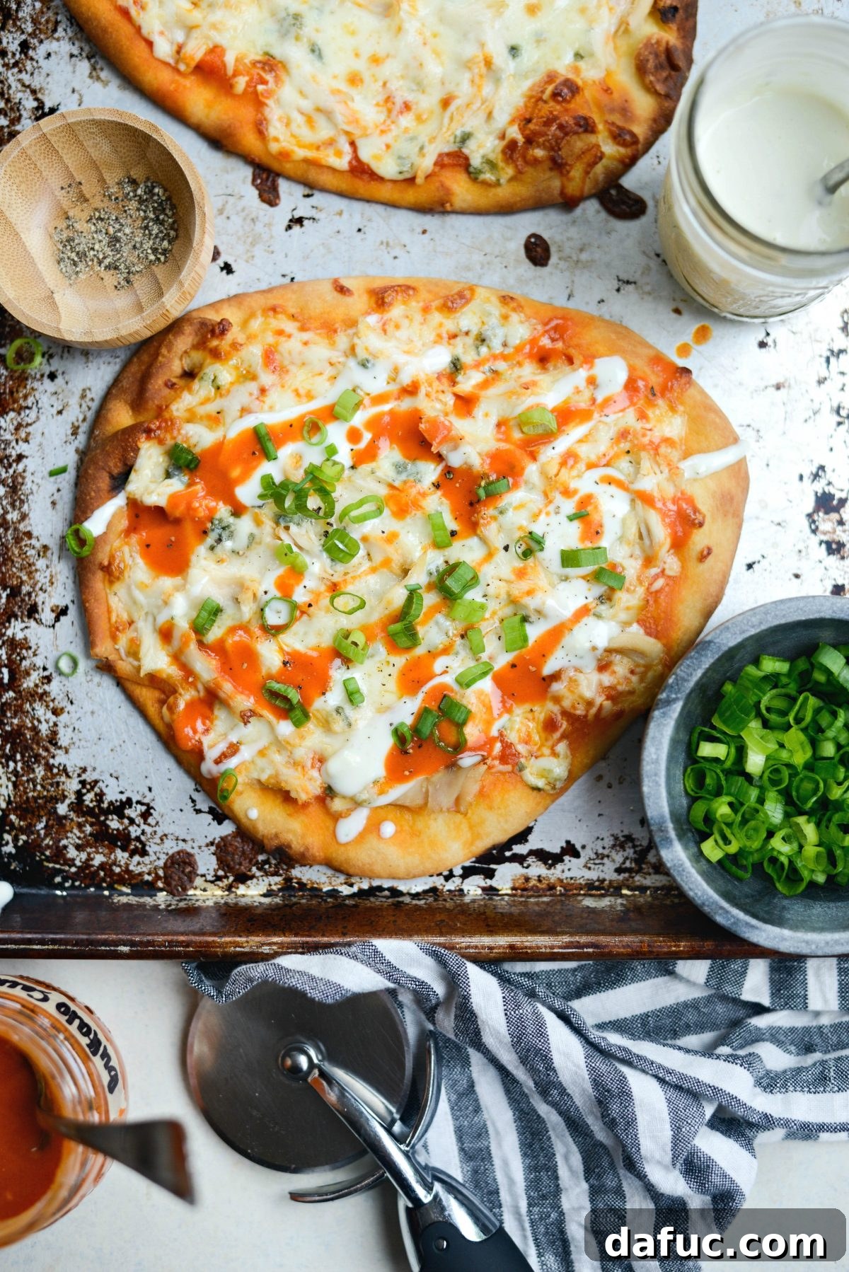 A close-up of a perfectly baked Buffalo Chicken Flatbread Pizza, ready to be enjoyed.