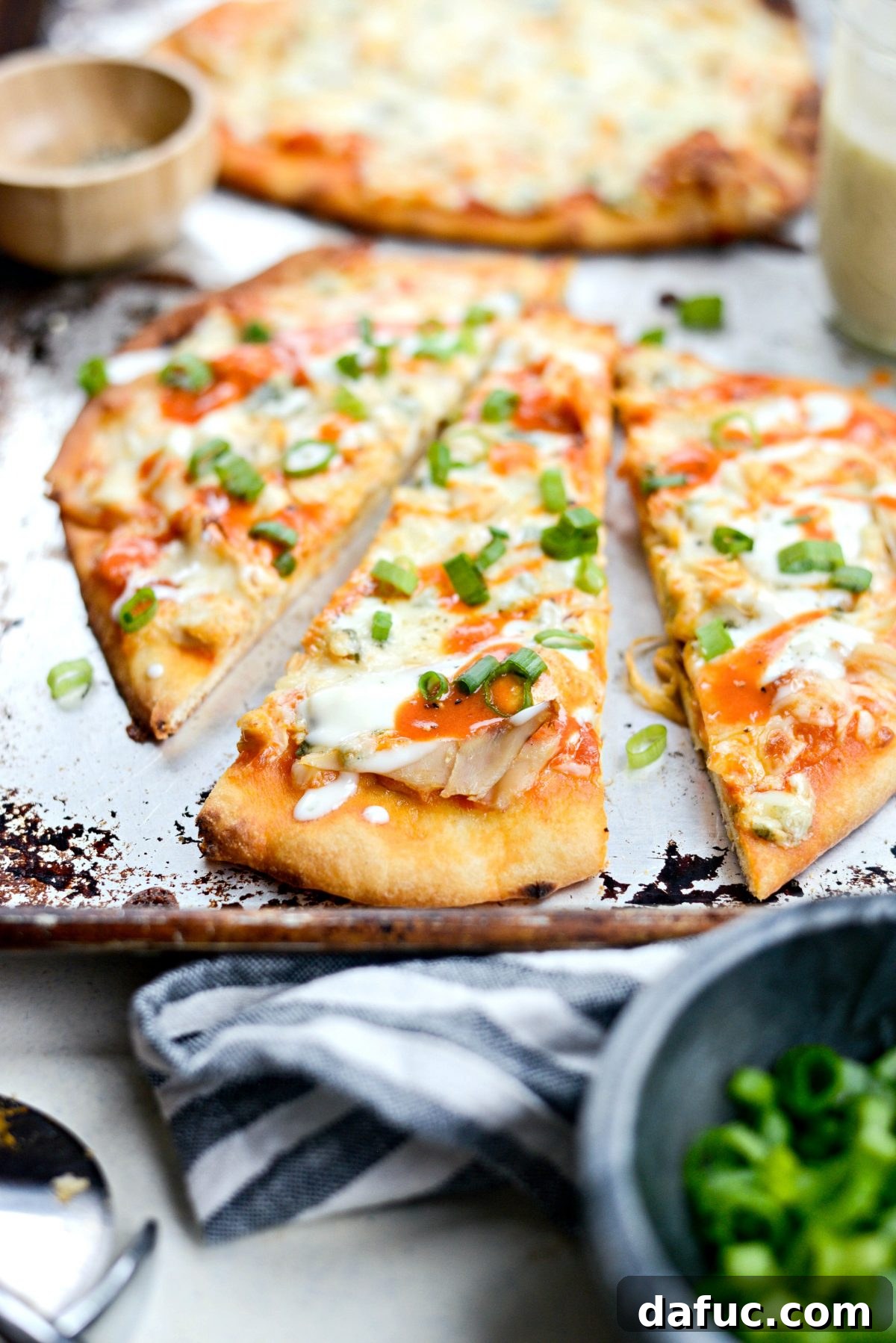 Sliced Buffalo Chicken Flatbread Pizzas arranged on a cutting board, showing the cheesy, chicken-filled interior.