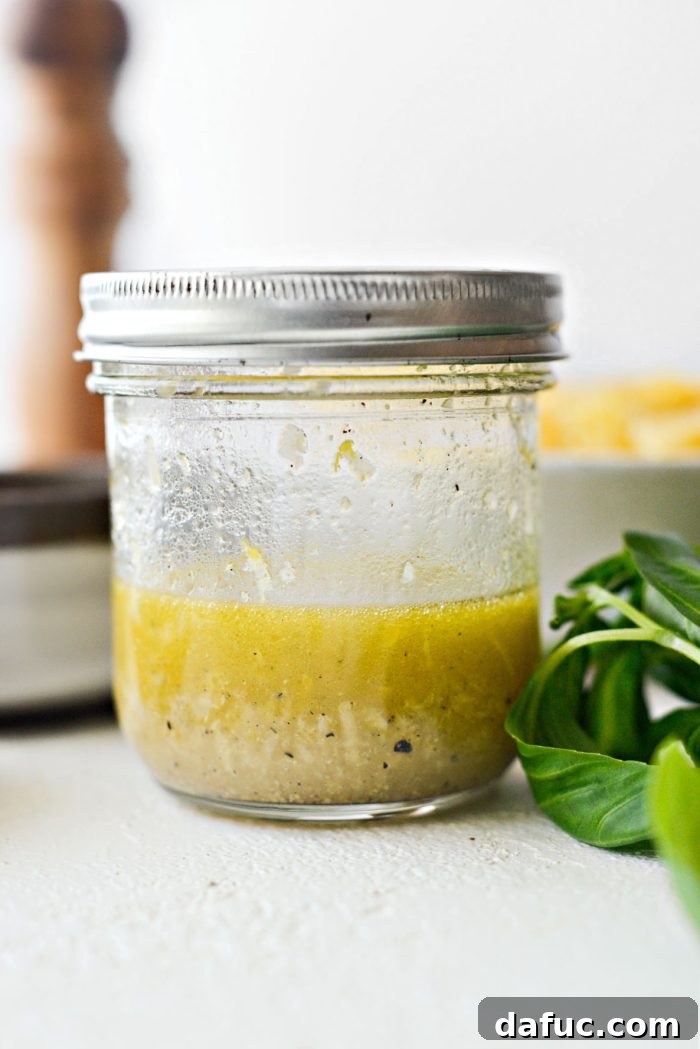 Bright Lemon Basil Parmesan Pasta Salad 6 Shaking the dressing ingredients in a jar to combine