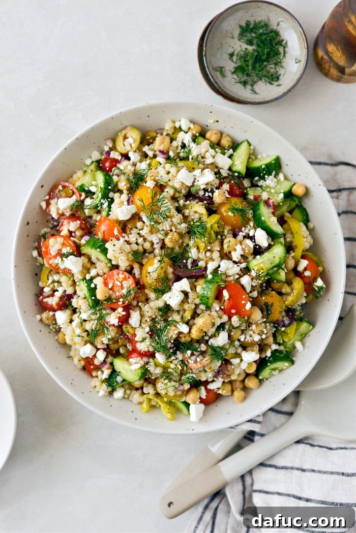 Vibrant Mediterranean Couscous Salad 12 Serving a portion of Greek Couscous Salad topped with extra feta and dill.
