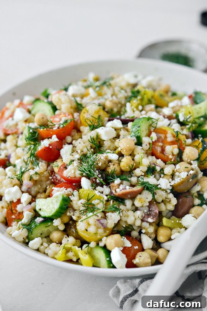 Vibrant Mediterranean Couscous Salad 3 Close-up of the mixed Greek Couscous Salad, highlighting the fresh vegetables and couscous texture.