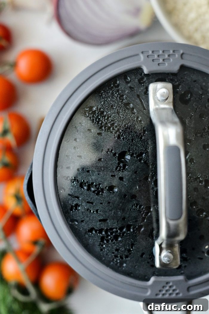 Vibrant Mediterranean Couscous Salad 6 Rinsing cooked couscous under cold water in a colander.