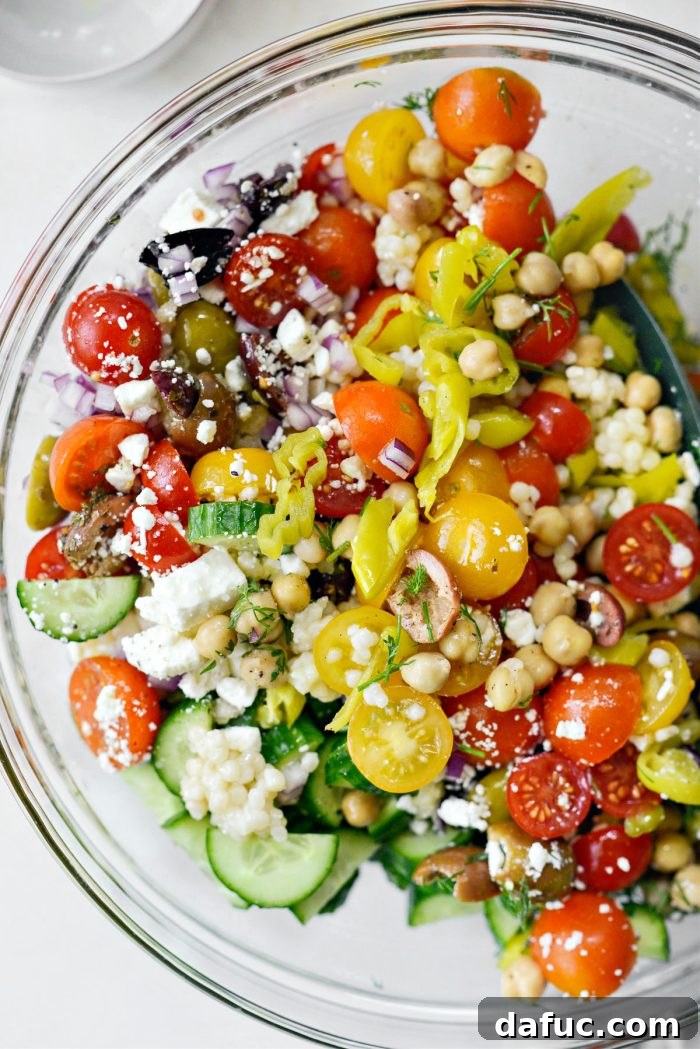 Vibrant Mediterranean Couscous Salad 9 Tossing the Greek Couscous Salad ingredients together.