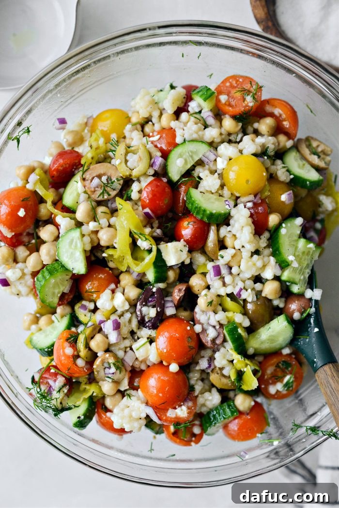 Vibrant Mediterranean Couscous Salad 10 Tasting the salad to adjust seasoning.