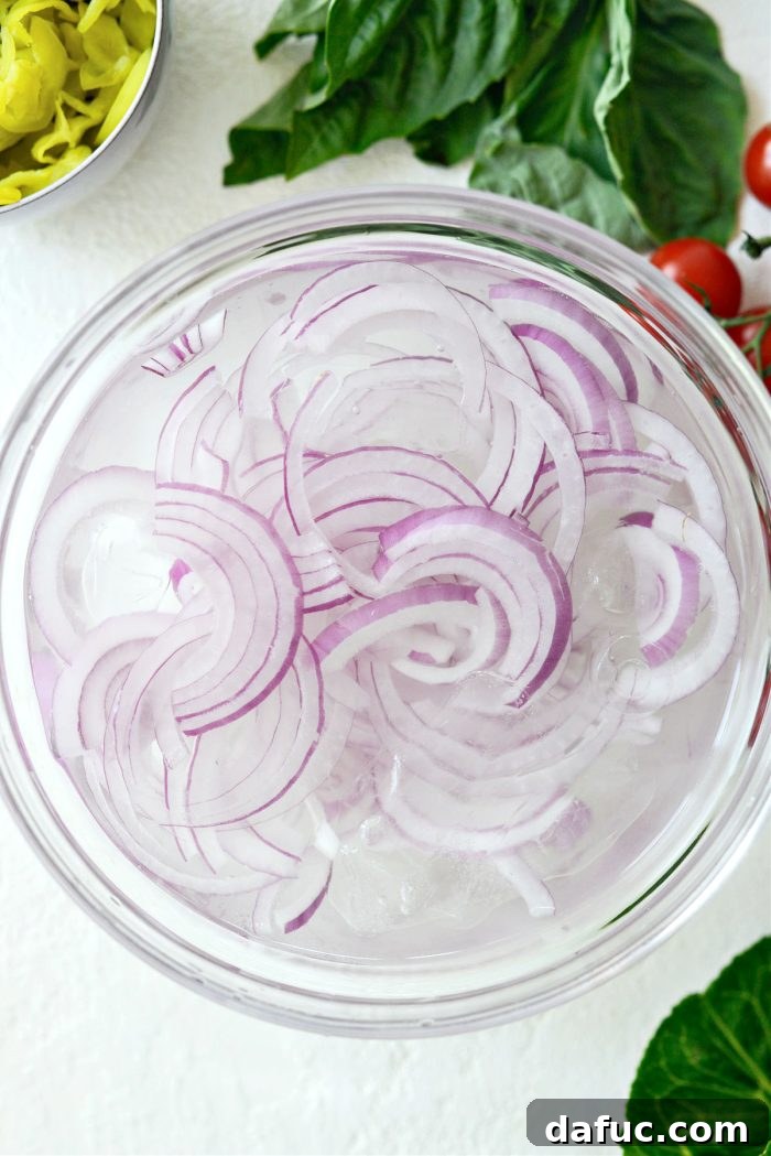 Sliced red onions soaking in ice water