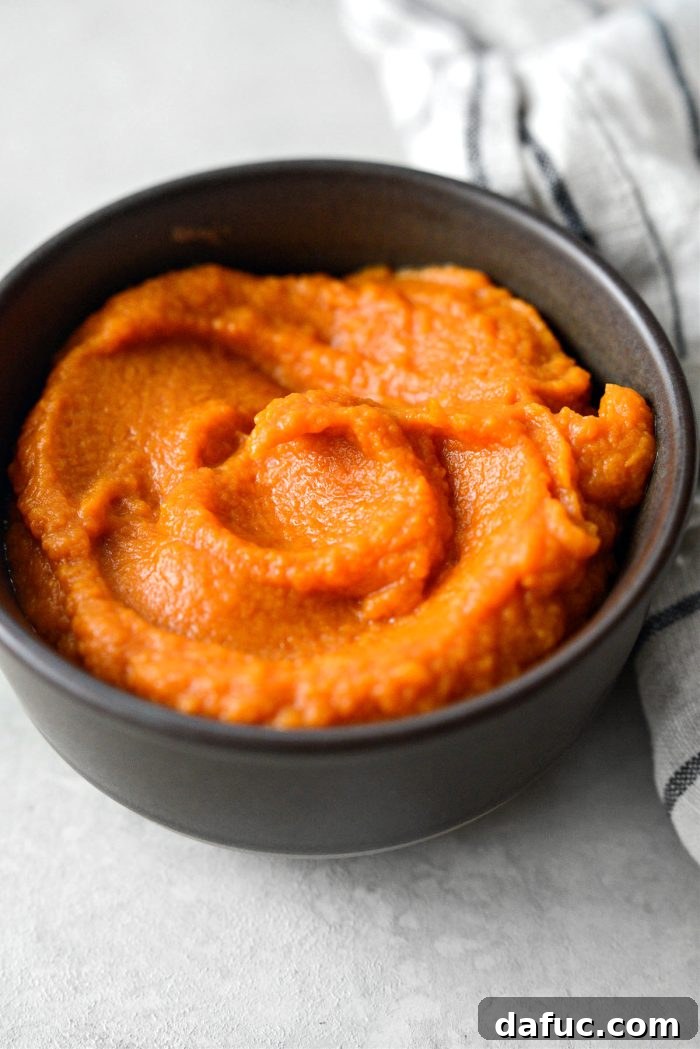Velvety Sweet Potato Puree 12 A large serving of sweet potato puree, inviting and ready to be used.
