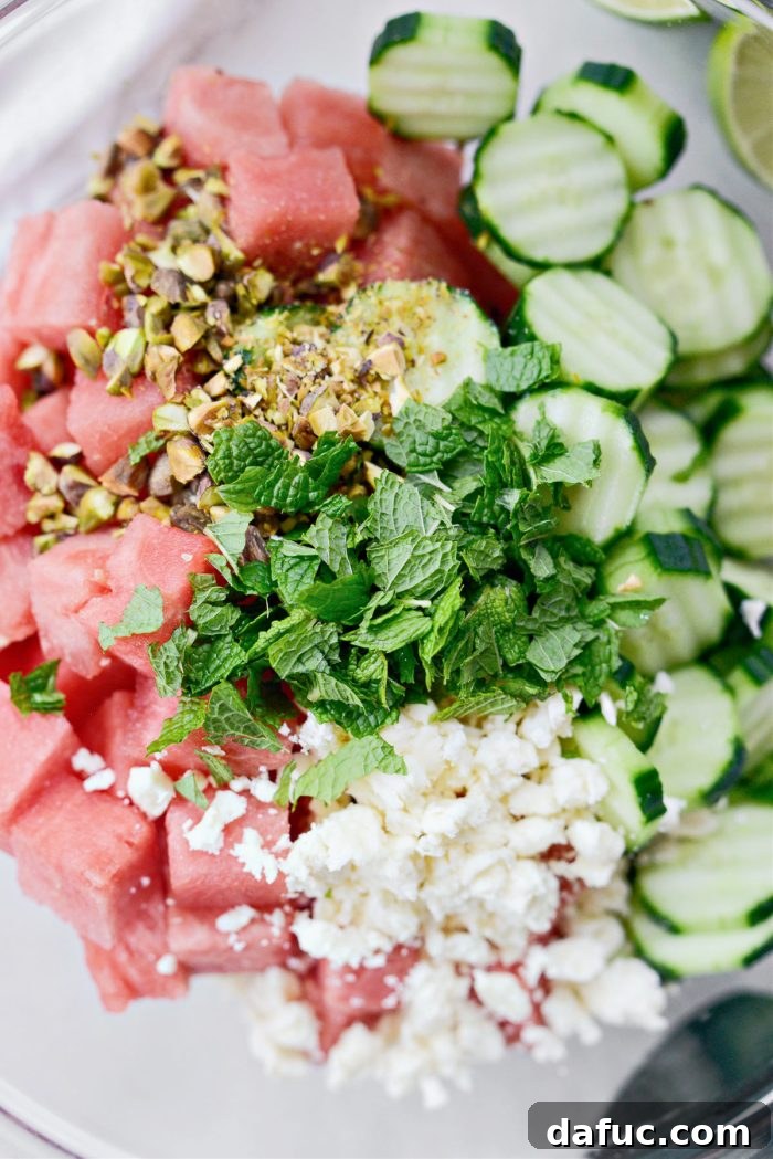 Refreshing Watermelon Feta Cucumber Salad 6 Combining watermelon, cucumber, feta, and pistachios in a bowl