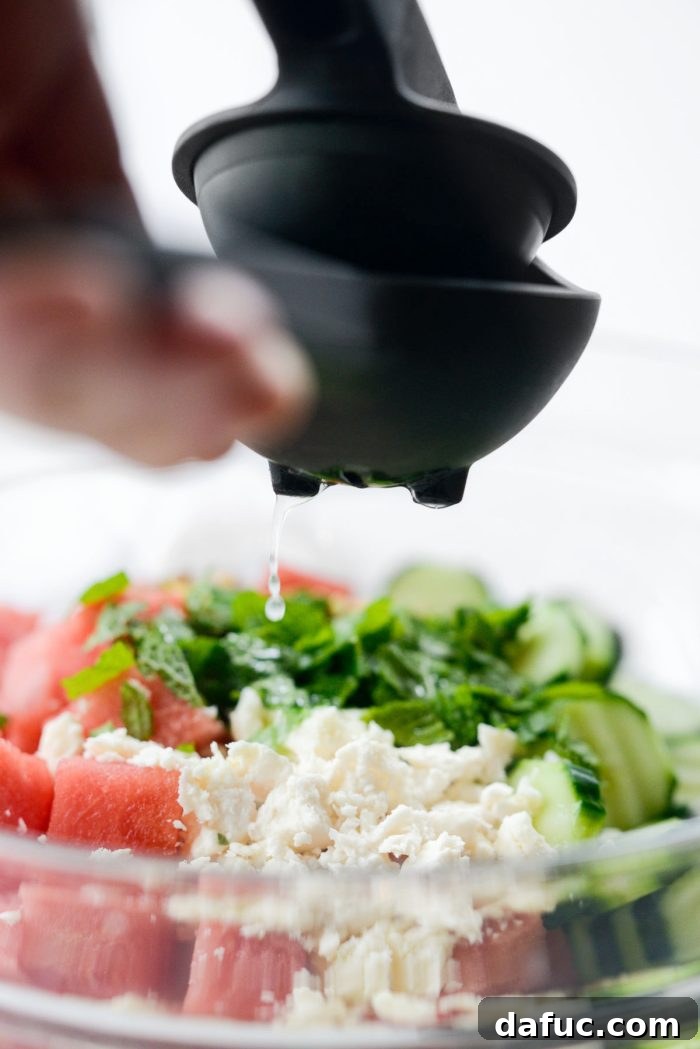 Refreshing Watermelon Feta Cucumber Salad 7 Adding fresh mint leaves to the salad ingredients