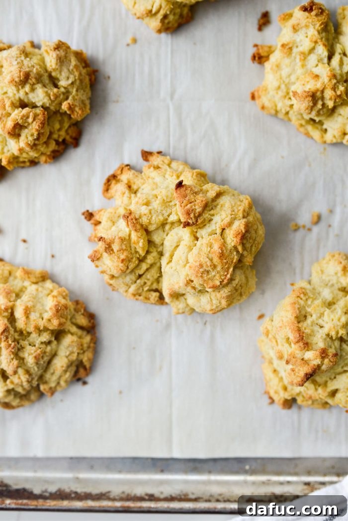 Effortlessly Fluffy Drop Biscuits 12 Close-up of a stack of freshly baked, golden brown easy homemade drop biscuits.