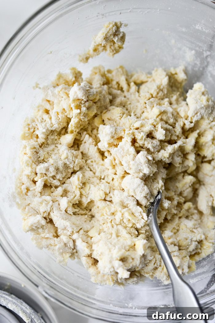 Effortlessly Fluffy Drop Biscuits 9 Close-up of shaggy, crumbly biscuit dough, indicating proper consistency.